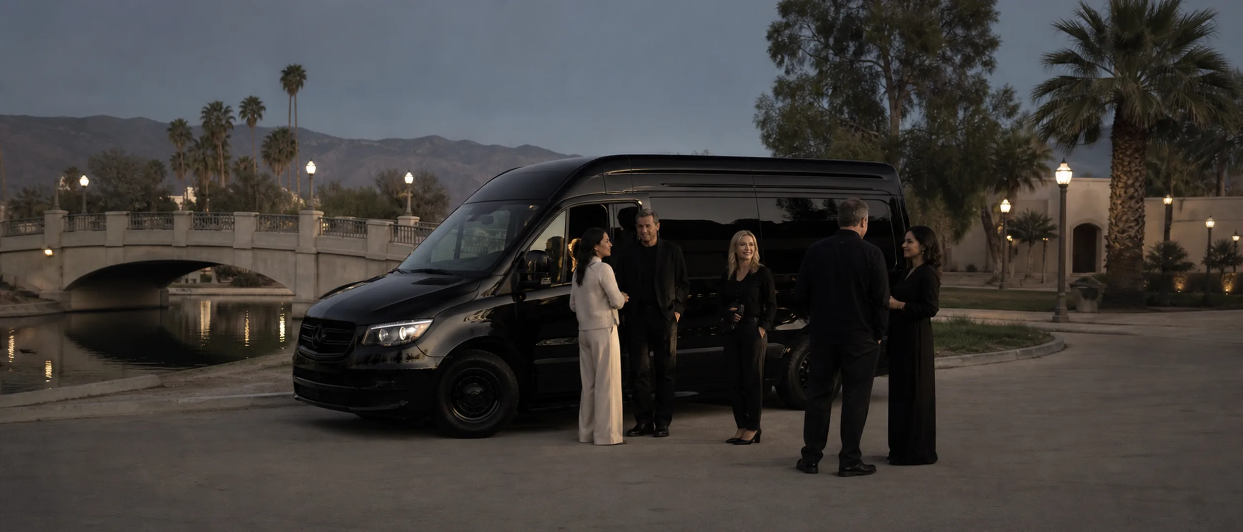 A private group gathers beside a black passenger van at Mill Creek Park in Bakersfield.